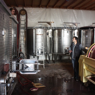 Guillaume Tardy talking to an employee who was cleaning a vat